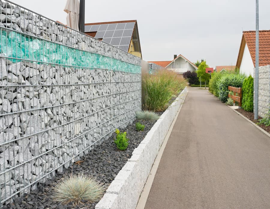 Stone filled gabion fence by a street