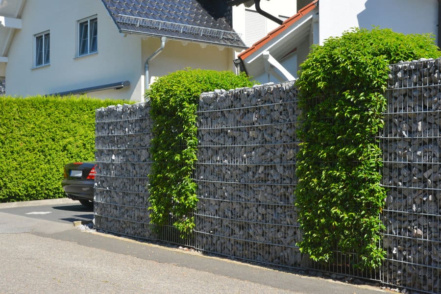 Gabion wall beside driveway and hedge