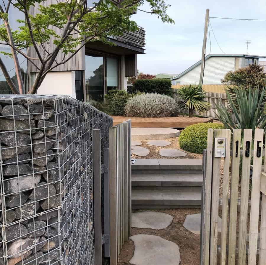 Pathway with gabion wall and modern gate