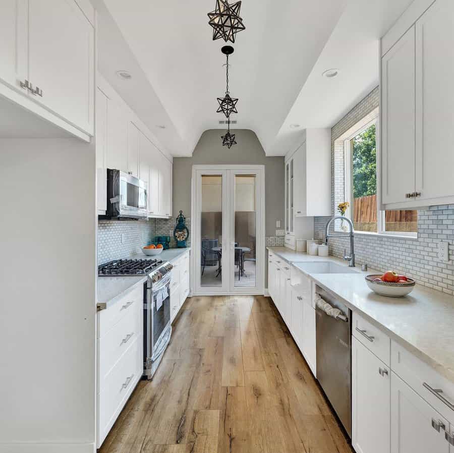 White kitchen with wooden flooring