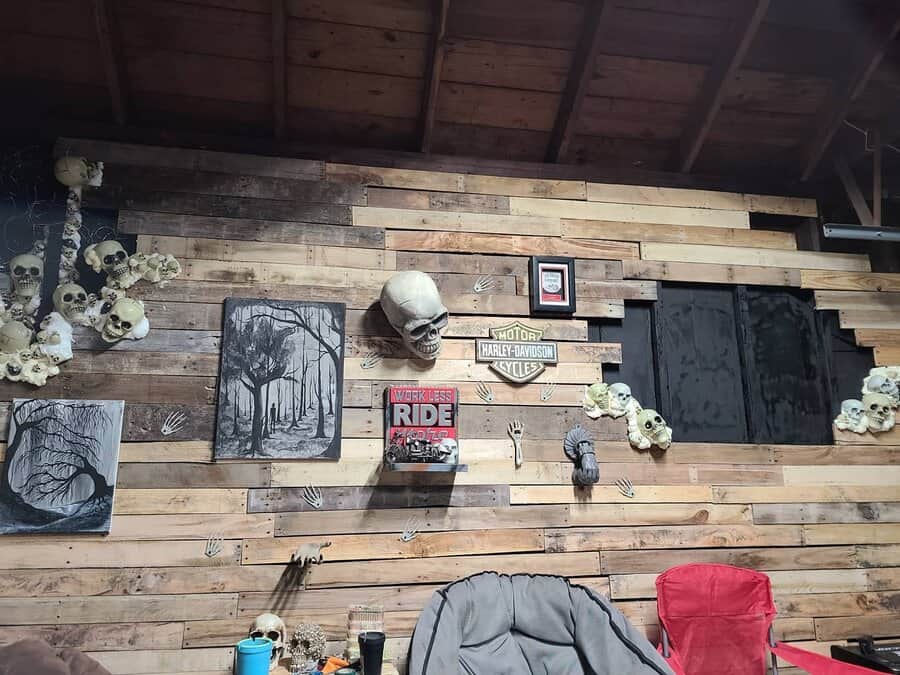 Garage wall with skull decor and motorcycle theme on pallet wood