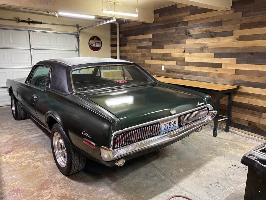 Vintage car in garage with pallet wood wall