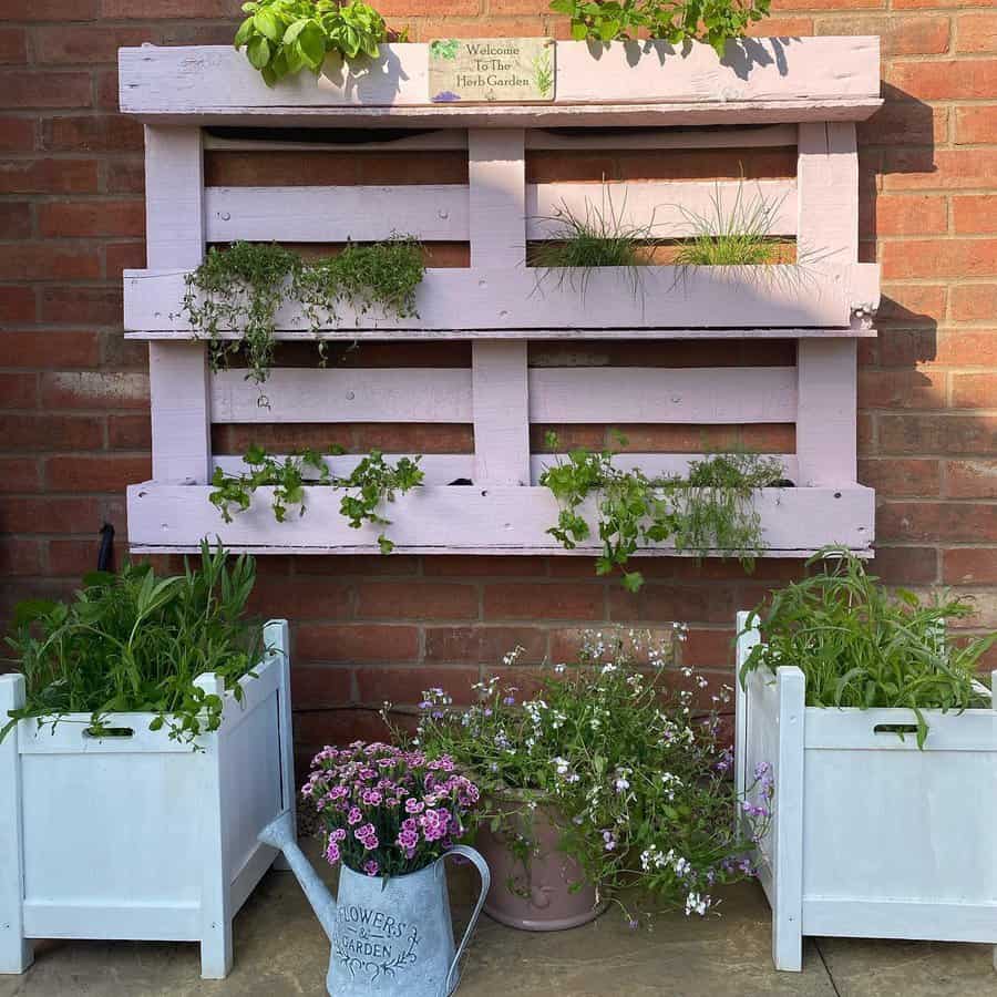 Vertical garden with pallet planter and flowering plants