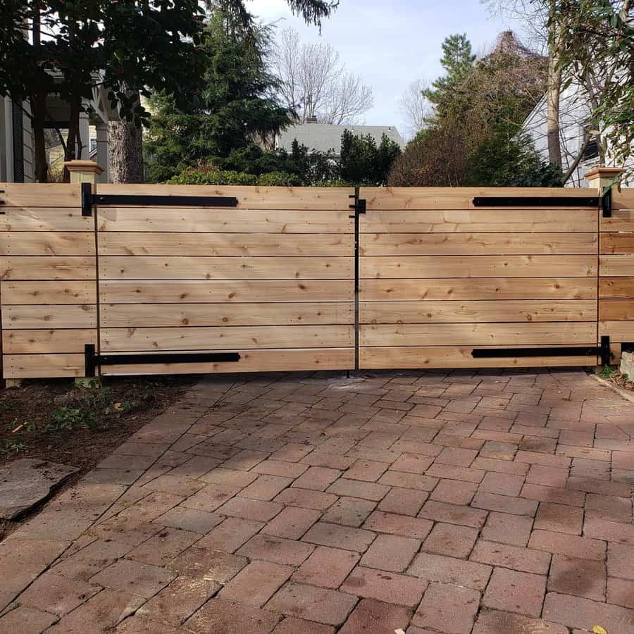 Wooden fence with greenery in front of a suburban home