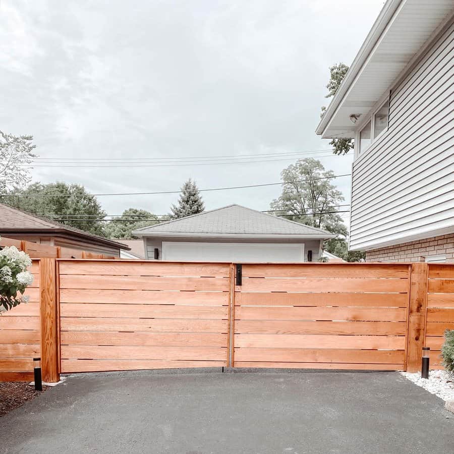 A wooden fence with a driveway