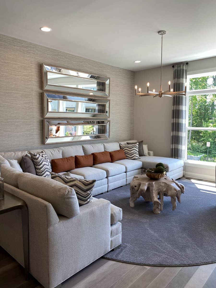 Stylish living room with textured wallpaper and modern chandelier