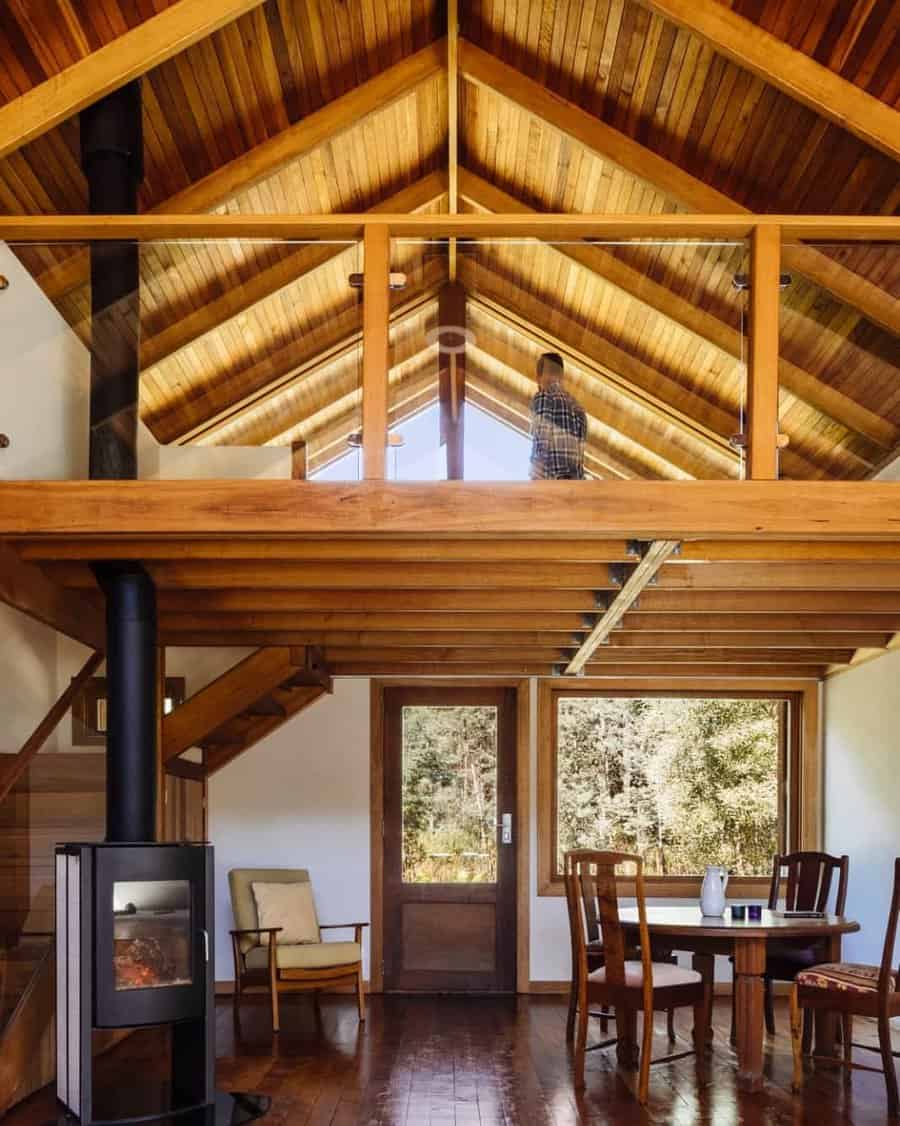 Cabin interior with loft and glass railing