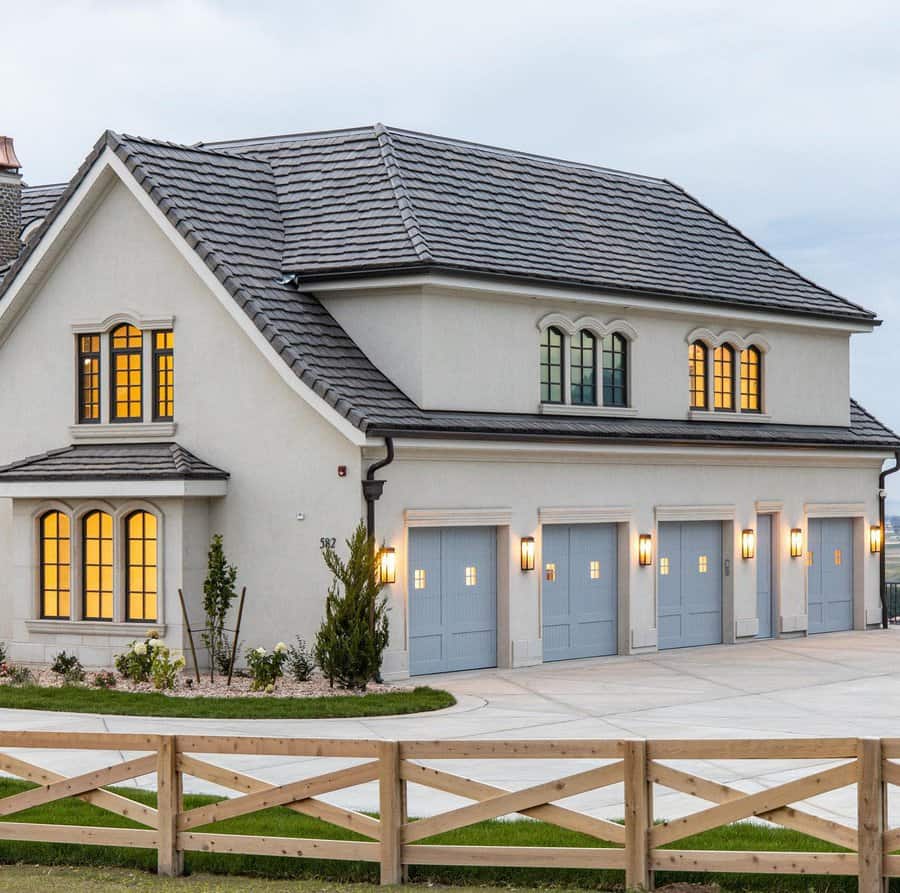 Elegant home with four blue garage doors