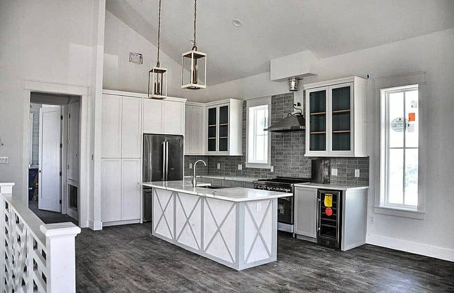 Spacious kitchen with gray tiles and white island