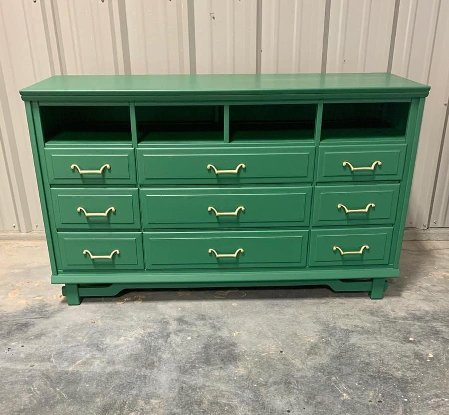 Large green dresser with gold handles and open storage compartments, combining a bold modern finish with classic functionality.