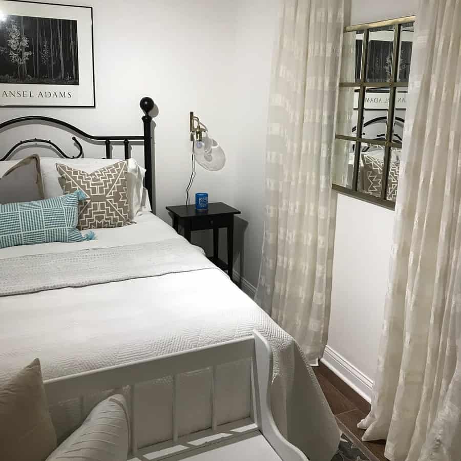 Chic bedroom with iron bed frame and soft linens