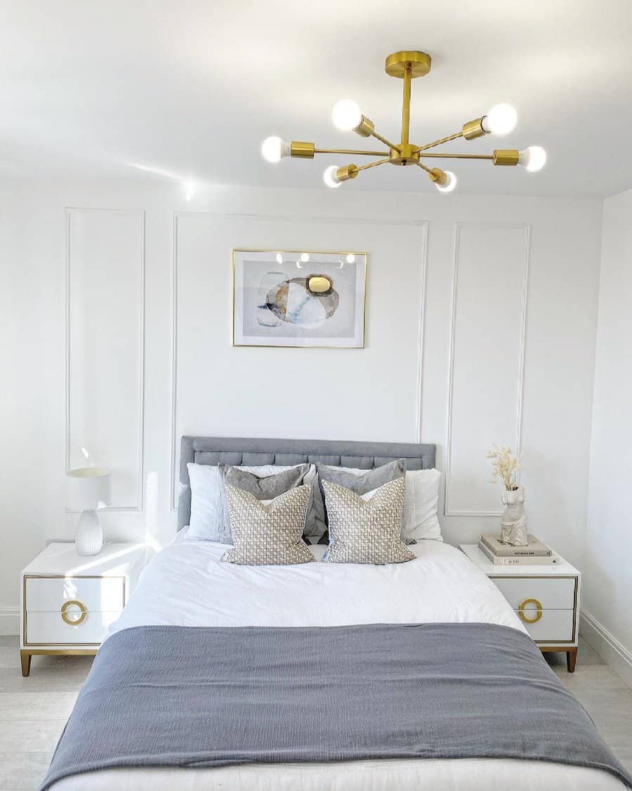 Sleek bedroom with modern light fixture and art