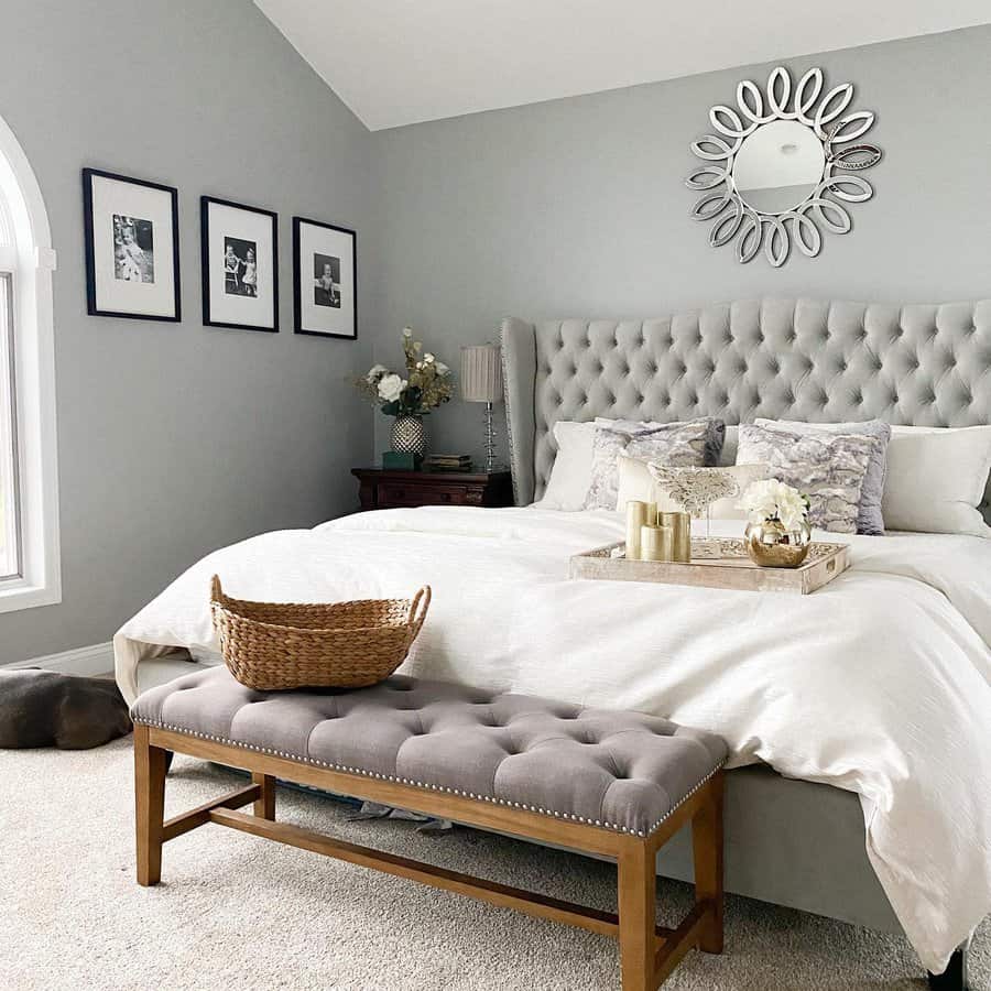 Serene bedroom with mirror accent and tufted bench