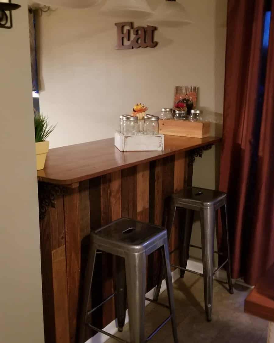 Cozy corner bar with wooden countertop and metal stools