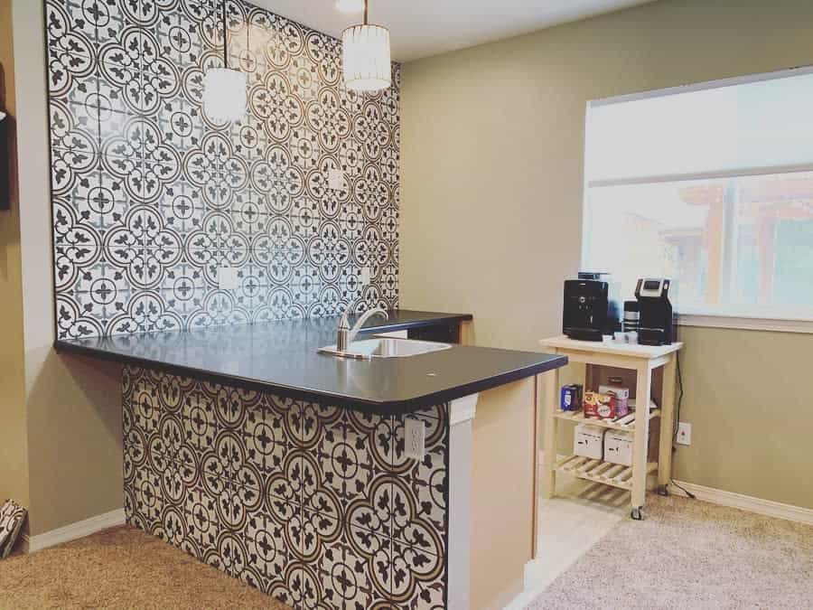 Kitchenette with patterned wall and pendant lighting