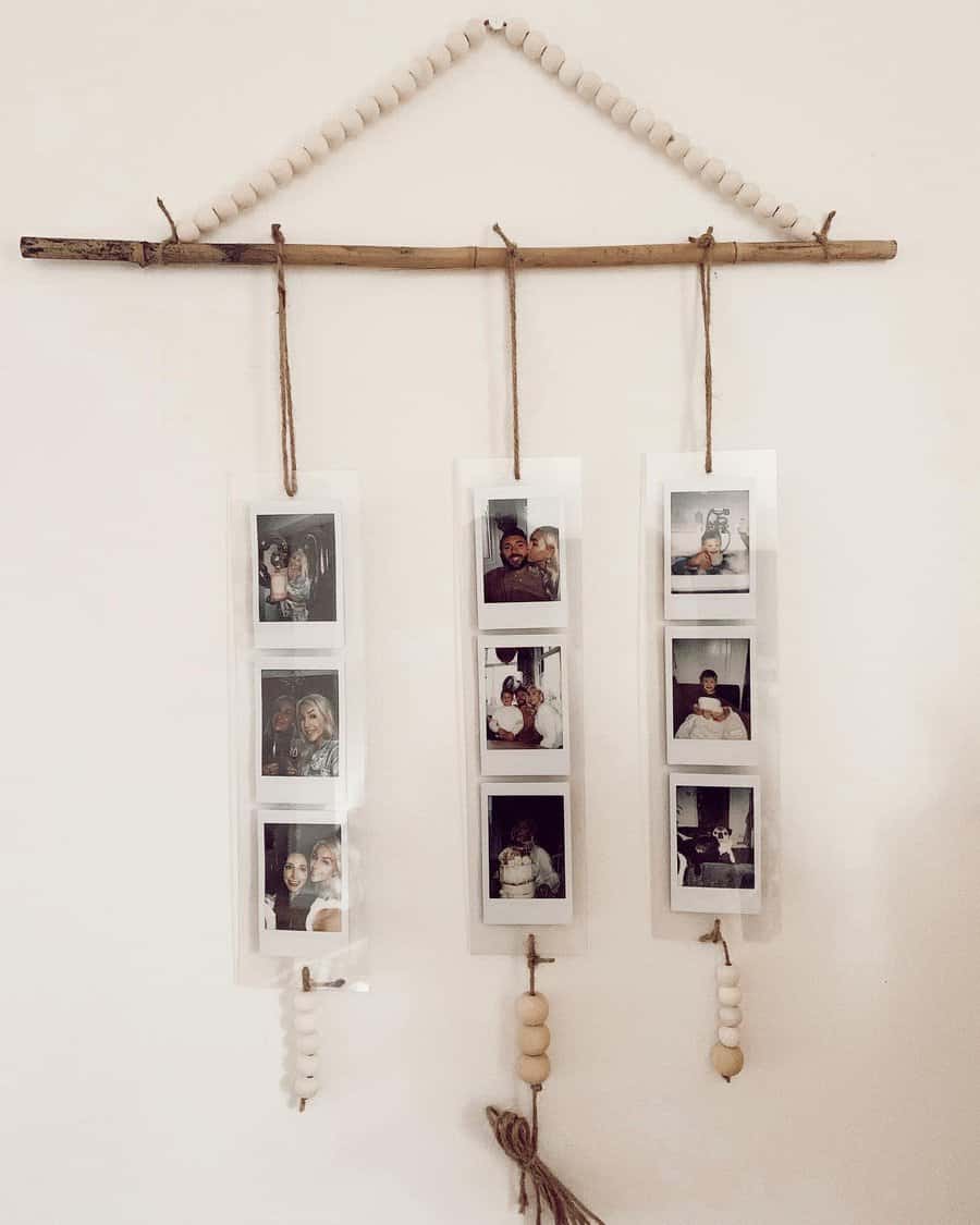 Wall decor with three strands of hanging polaroid photos, suspended from a wooden stick, adorned with white beads