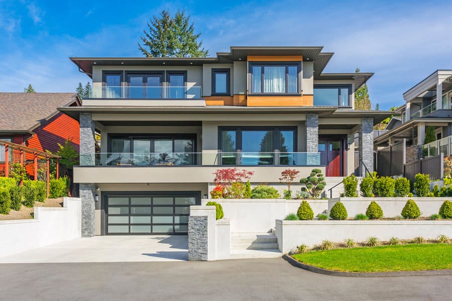 Modern house with geometric landscaping and glass balcony