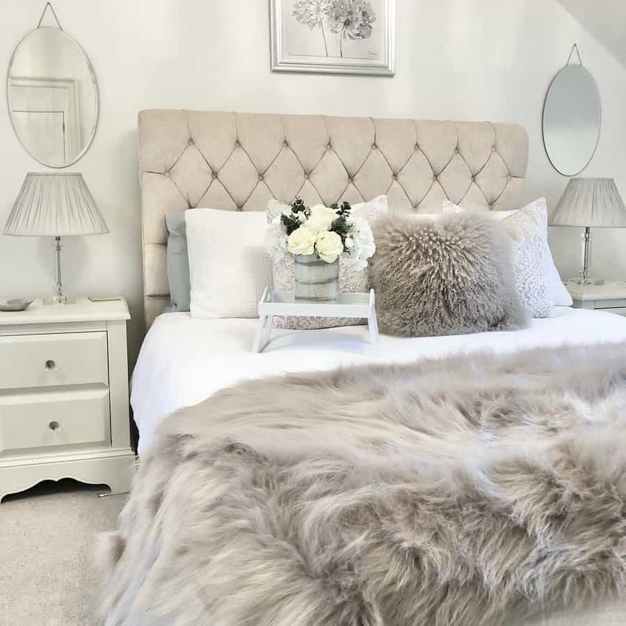 Chic bedroom with furry throw and mirrored accents