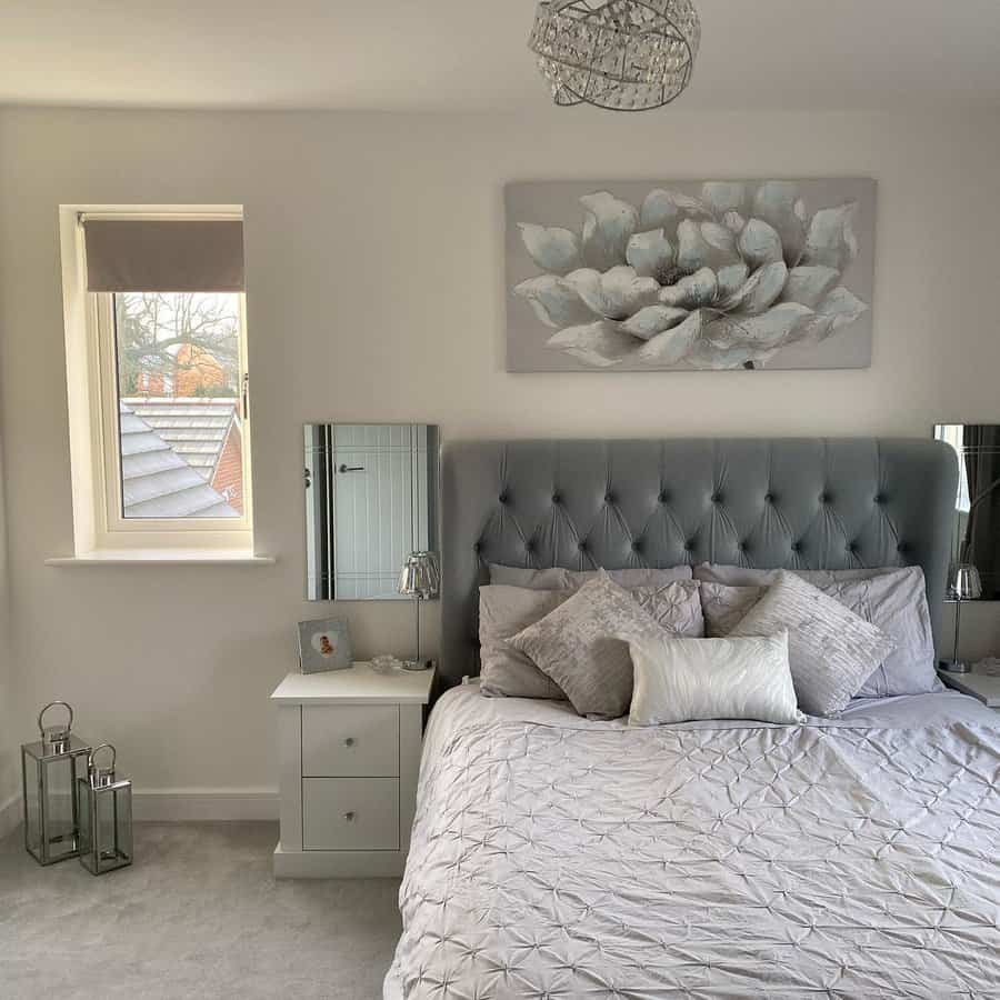 Tranquil bedroom with floral art and a grey tufted headboard