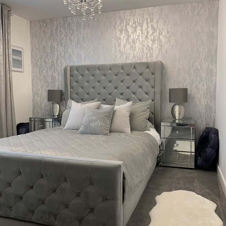 Luxurious grey bedroom with textured wallpaper and crystal chandelier