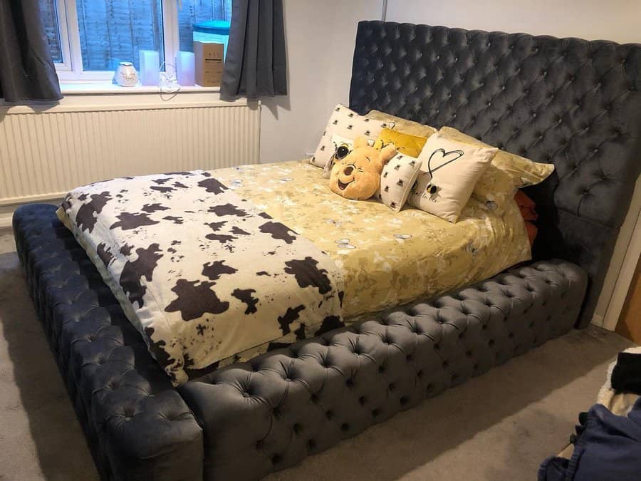 Cozy bedroom with tufted grey bed and playful bedding