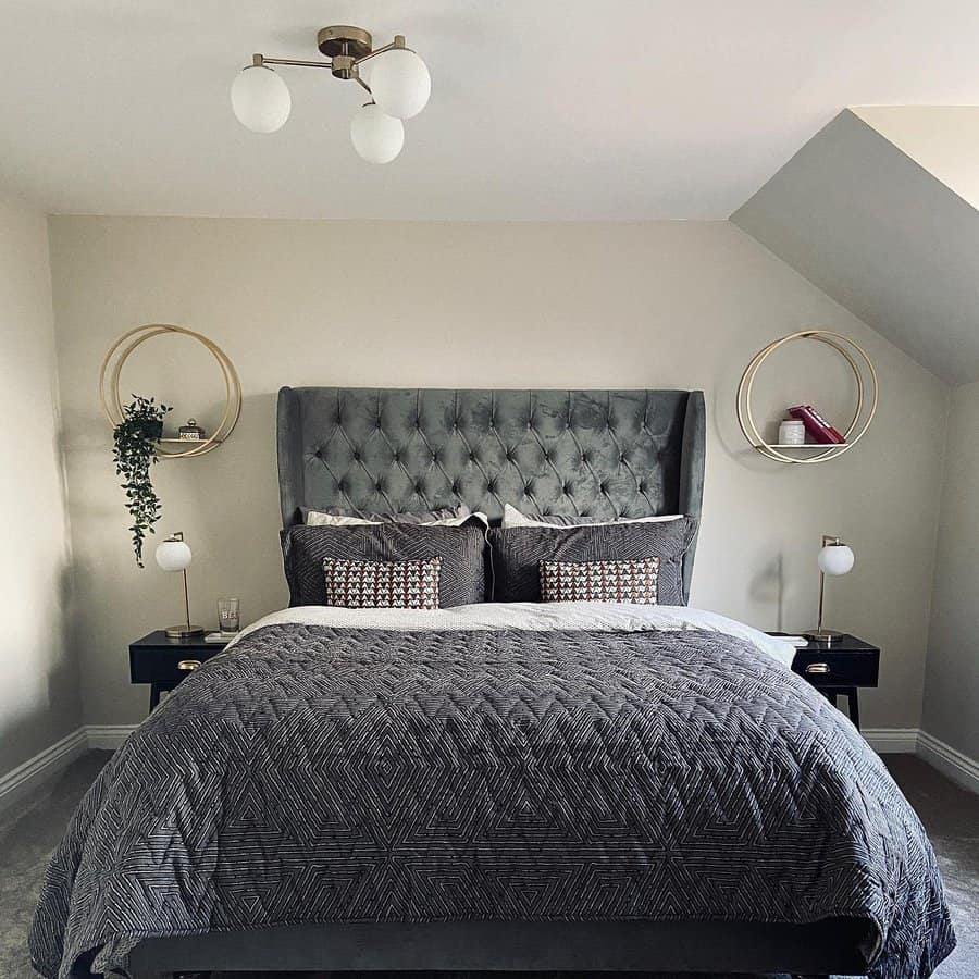 Modern bedroom with grey tufted headboard and geometric bedding