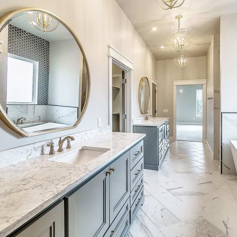 Luxurious bathroom with marble countertops and gold mirrors