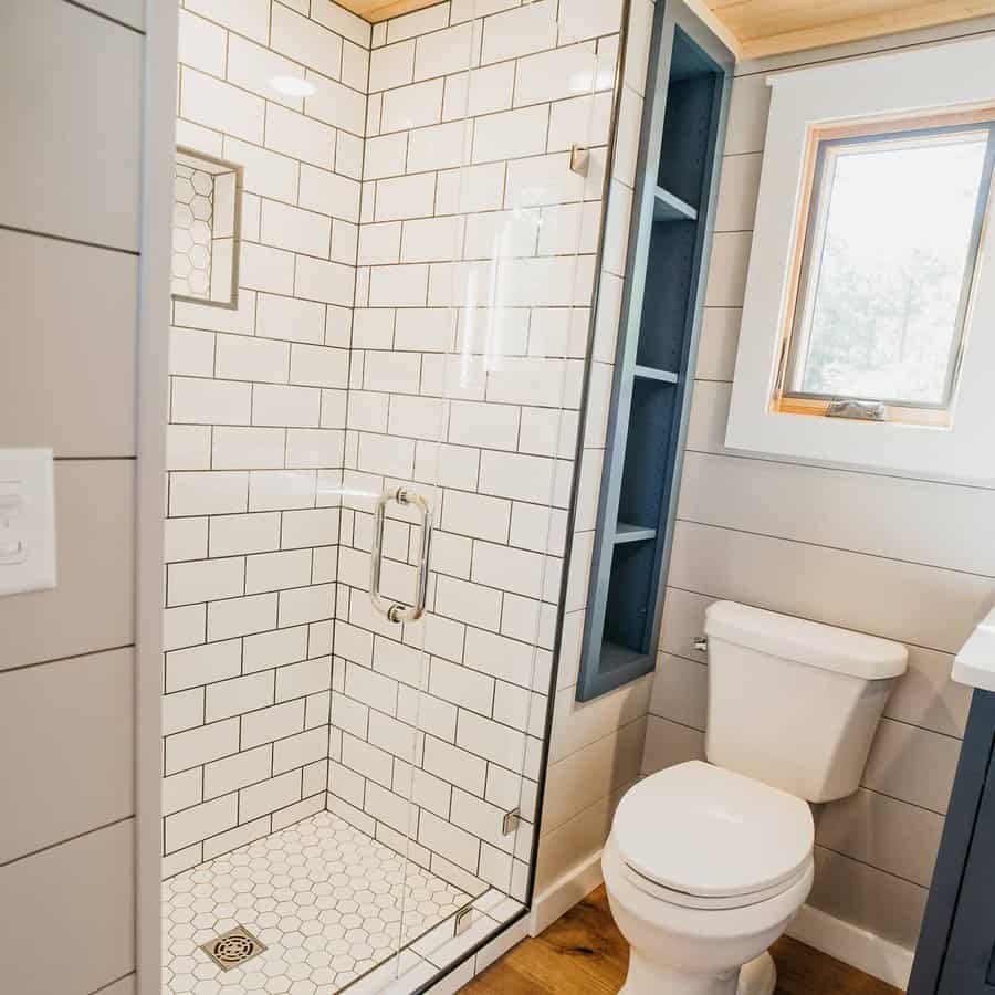 Compact bathroom with subway tiles and glass shower