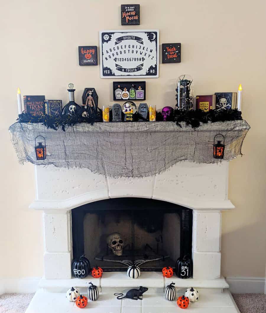 Halloween-themed fireplace mantel with decorations, including skulls and pumpkins