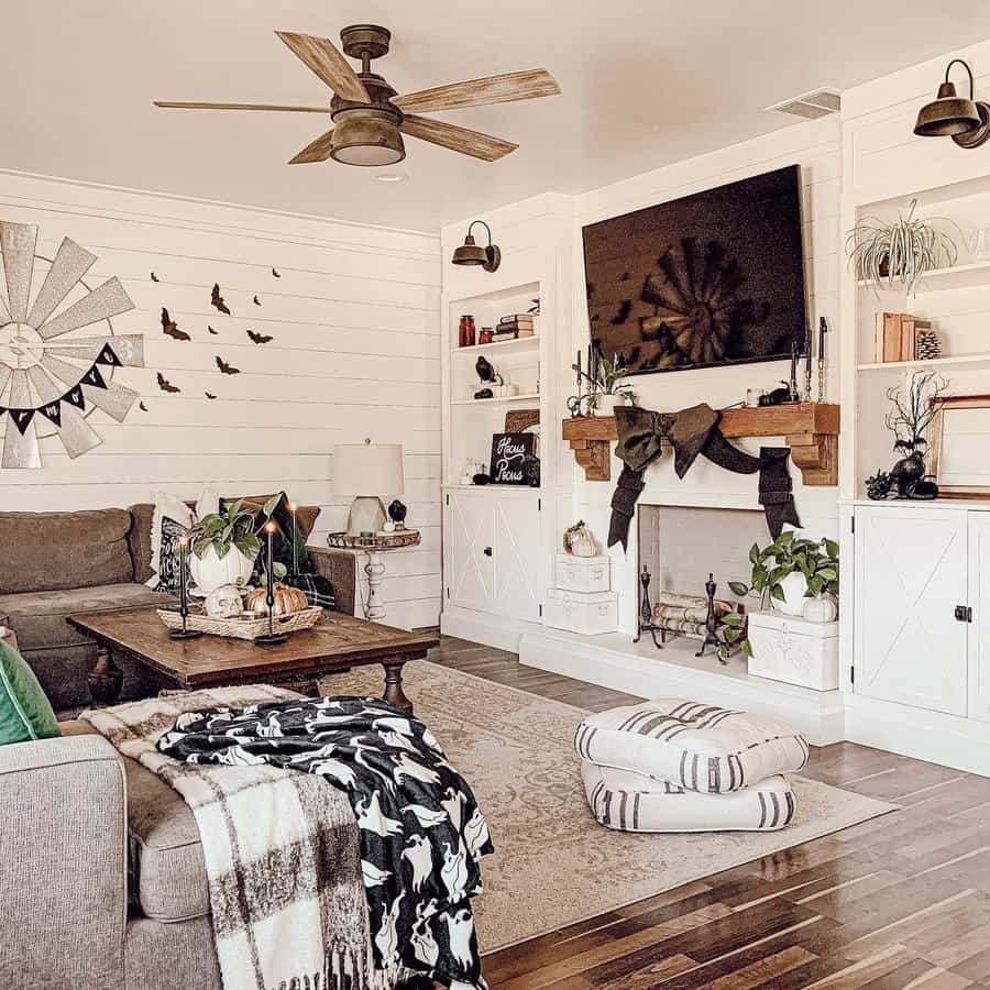 Cozy living room with a corner sectional, TV above fireplace, and farmhouse decor