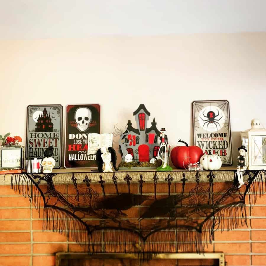 Halloween-themed mantel with spooky decorations and signs above a fireplace