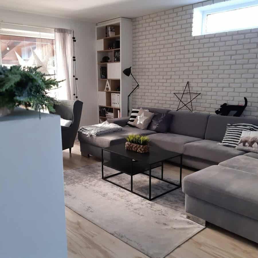 Scandinavian living room with brick wall and gray sofa