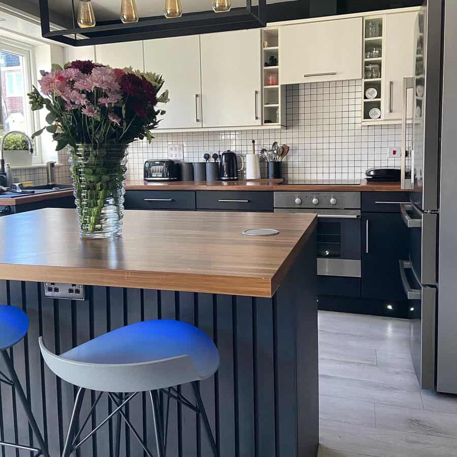 Modern kitchen with wooden bar counter and blue stools