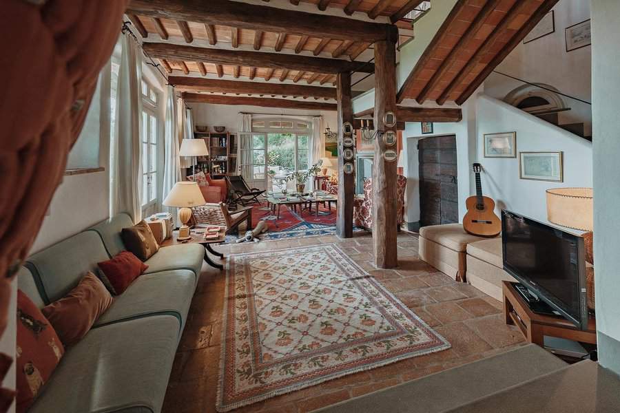 Quaint rustic living room with exposed beams and a guitar