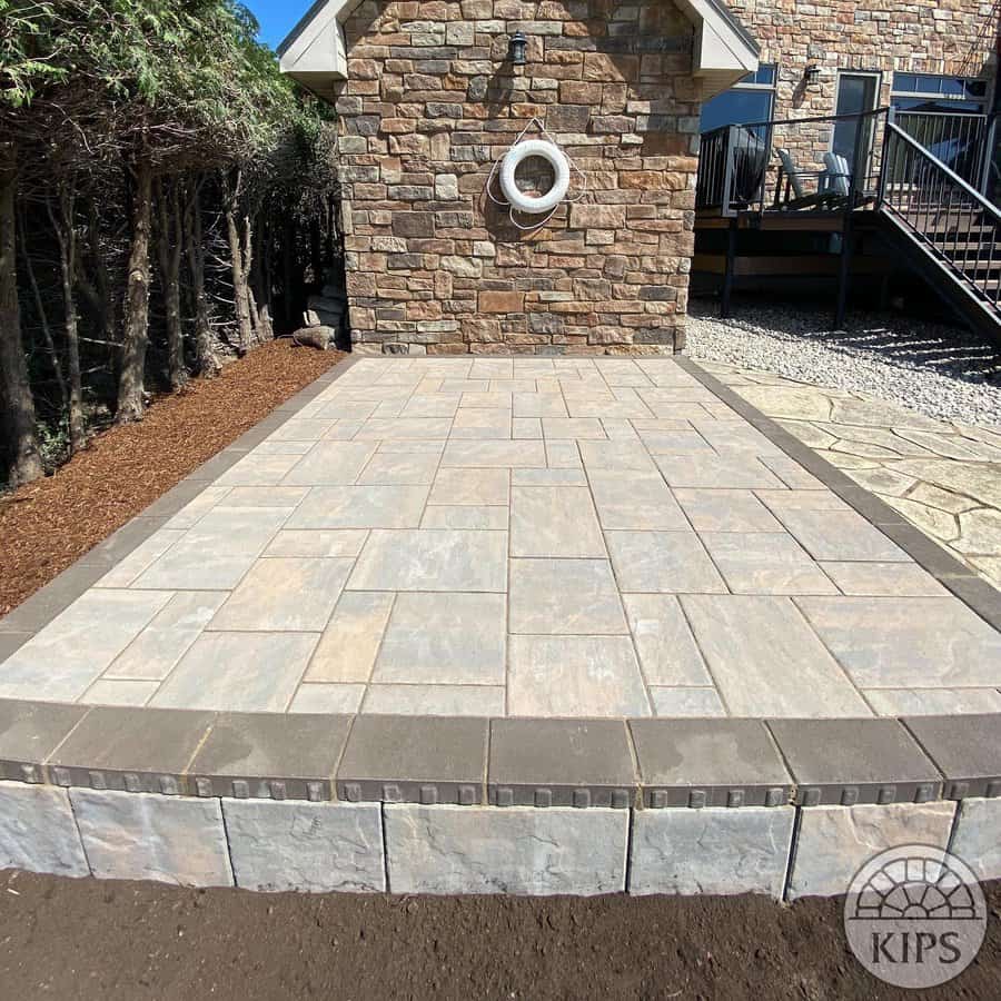 Patio with stone tiles against a stone wall with lifebuoy decor