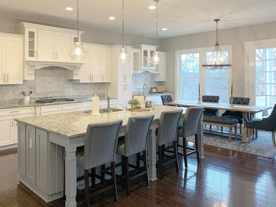 Inviting kitchen with white cabinets and dining area