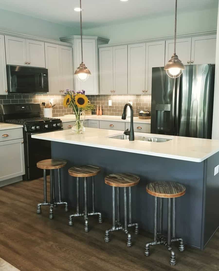 Stylish kitchen with navy island and industrial stools