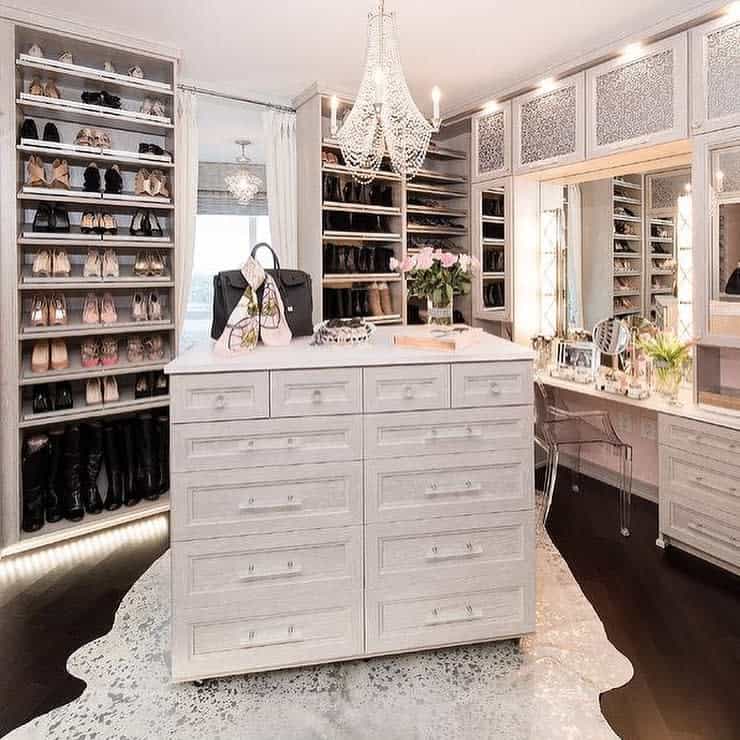 Walk in closet with island cabinet