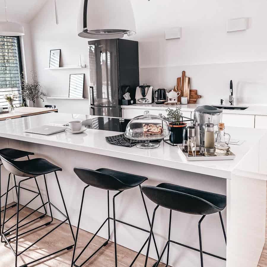 white kitchen with wooden flooring