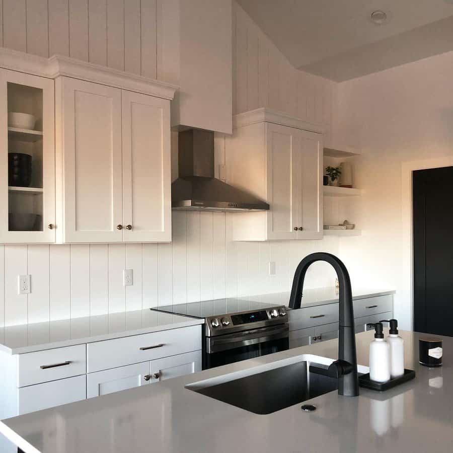 Modern kitchen with white shiplap walls and black accents