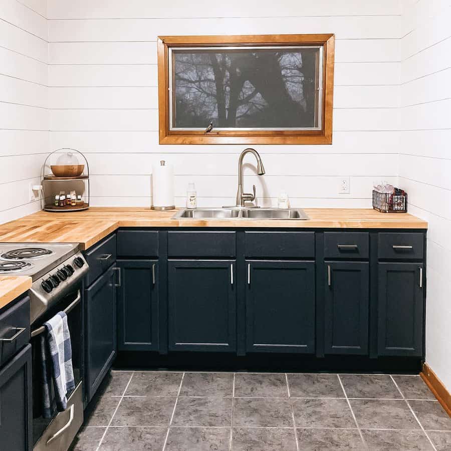 Kitchen with white shiplap walls and dark cabinets