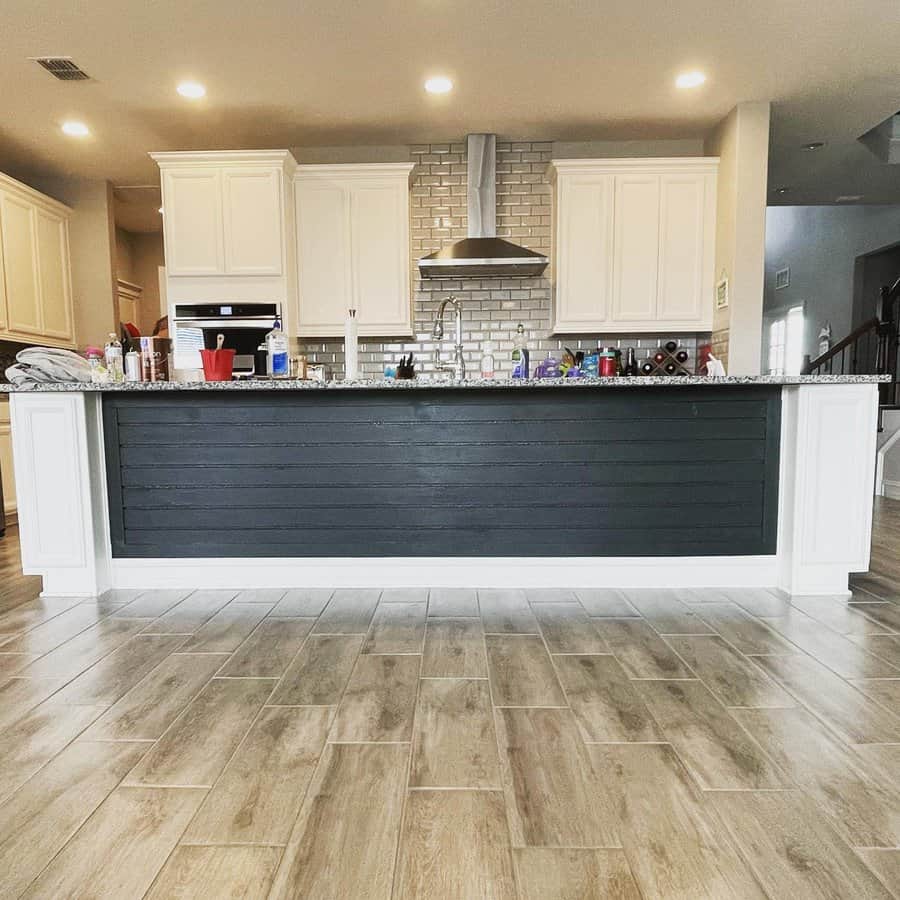 Spacious kitchen with shiplap island and brick backsplash