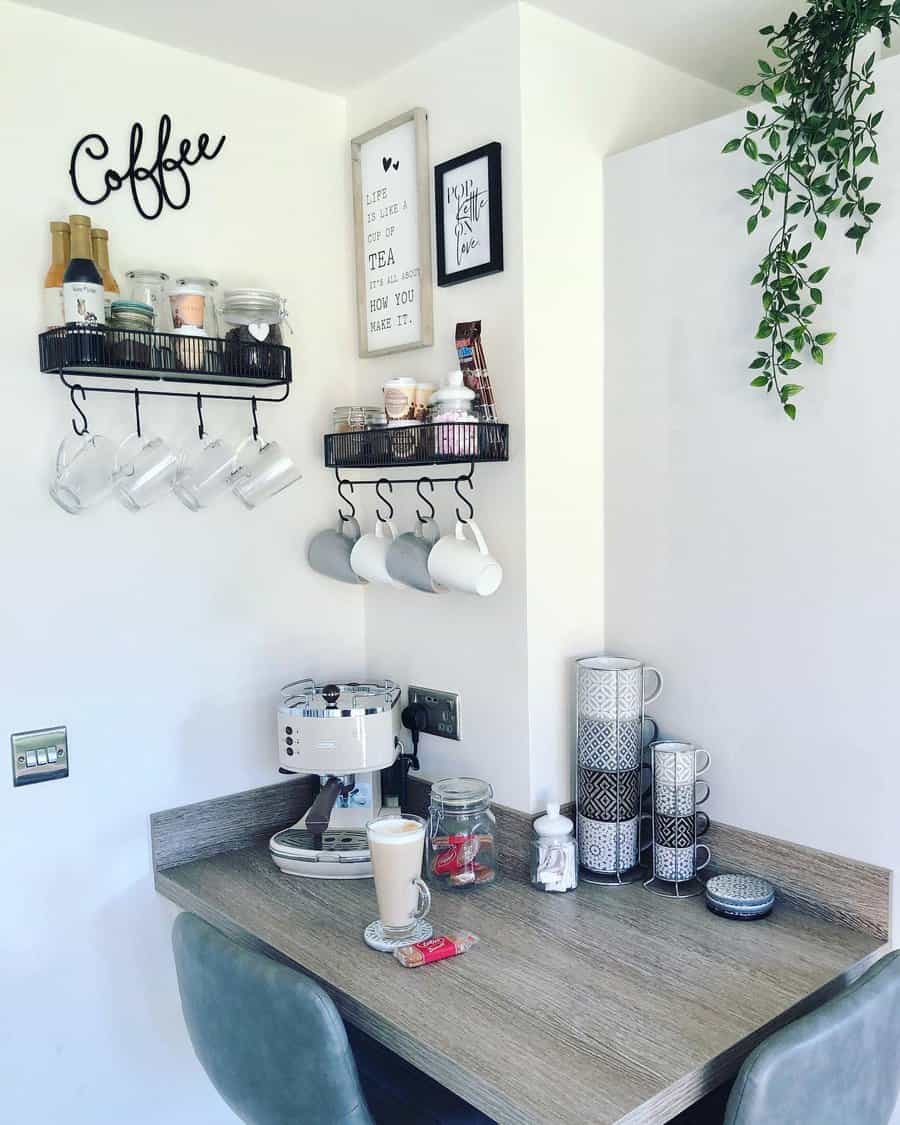 Cozy coffee nook with mugs, espresso machine, latte, and jars; wall shelves hold decor and cups; hanging plant adds greenery