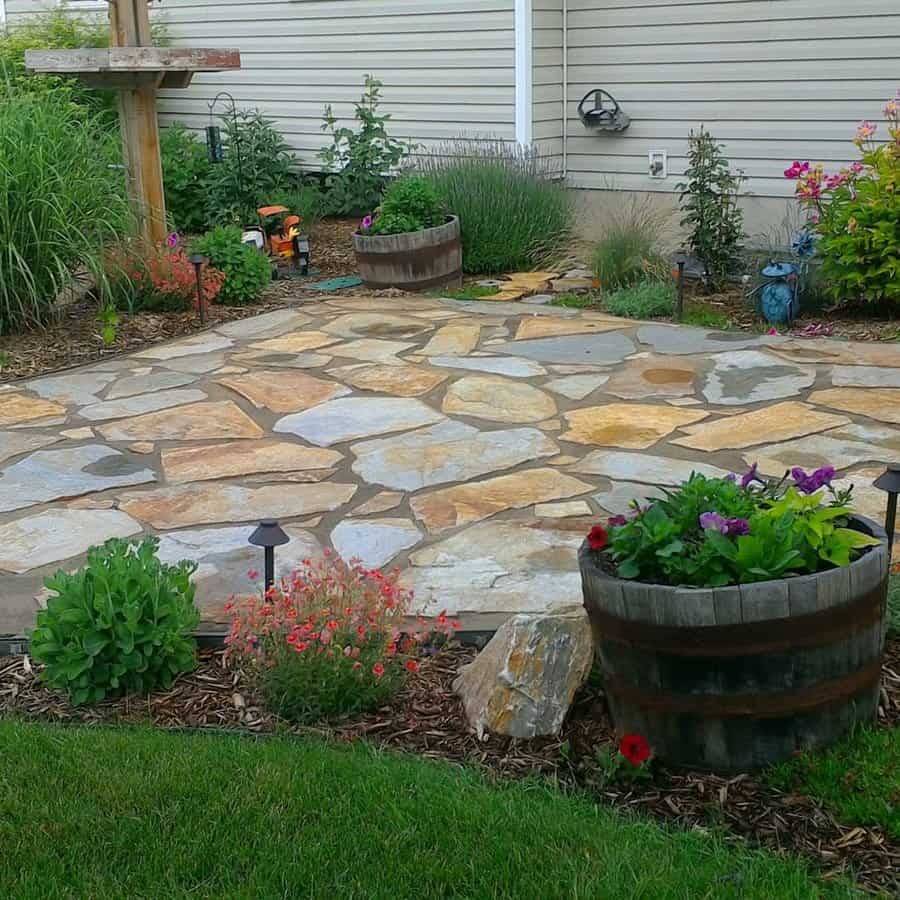 Flagstone patio with garden and blooming planters