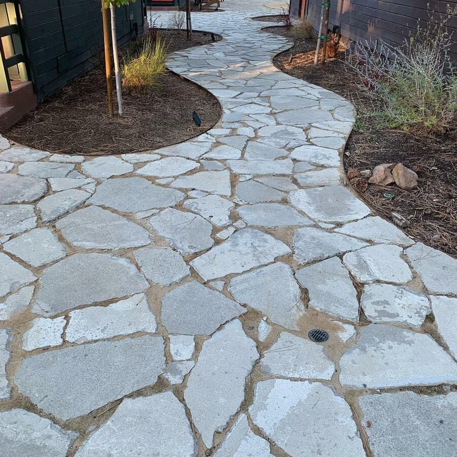 Curving stone walkway with landscaping