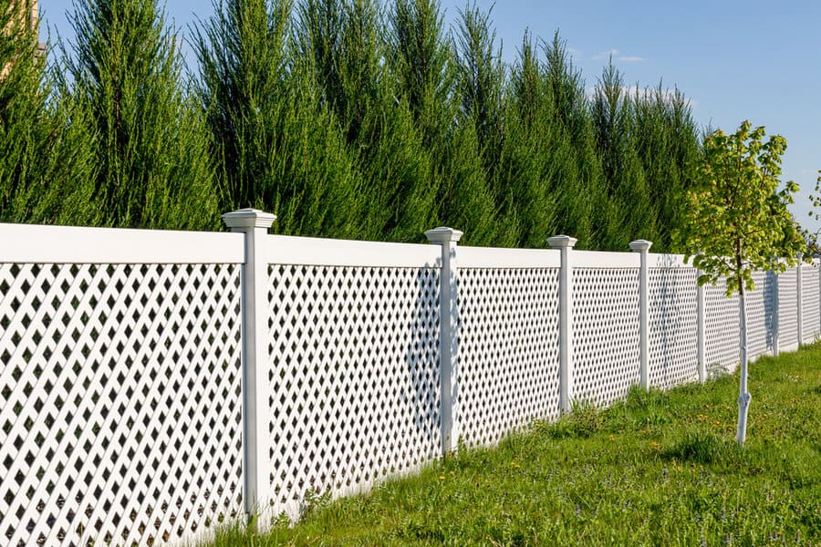 White lattice fence with column caps