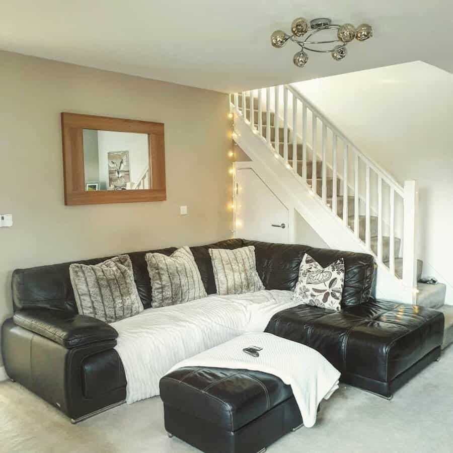 Modern living room with a leather sofa and stair lights