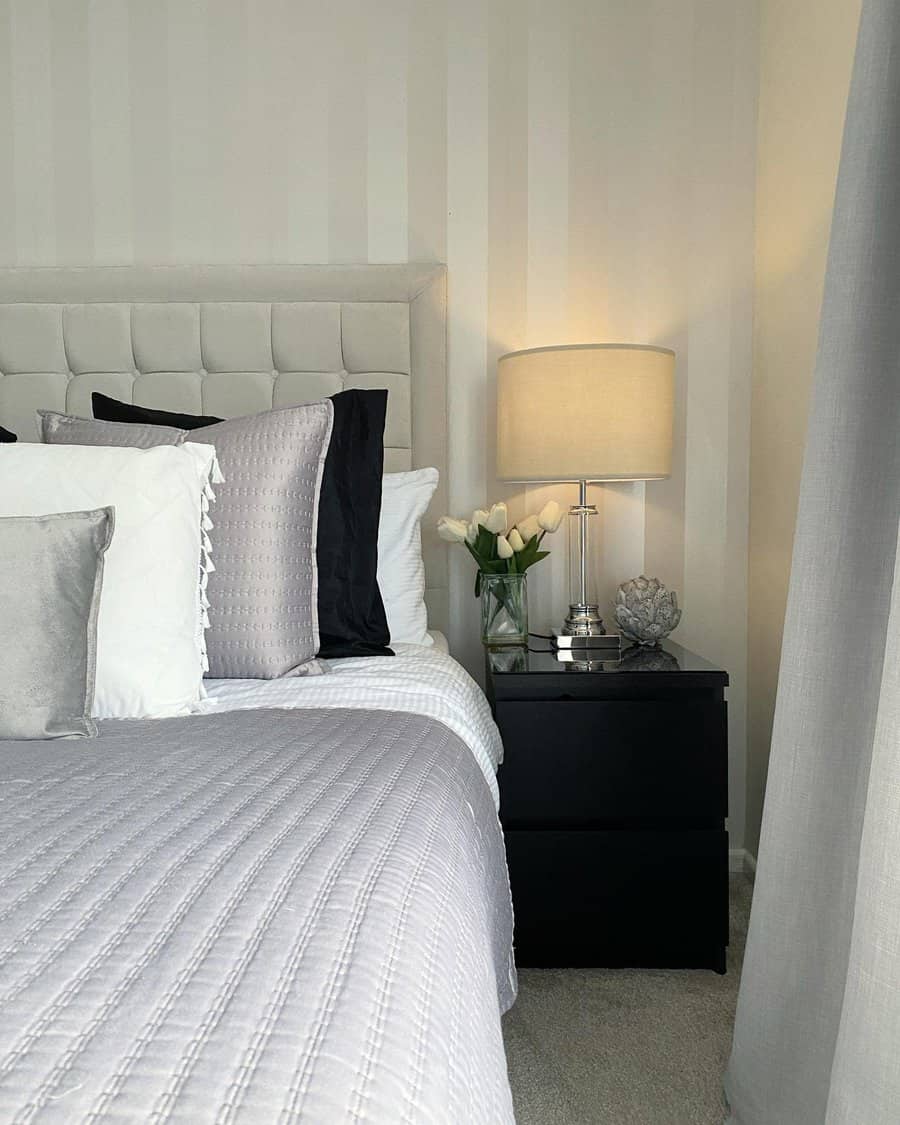 Elegant bedroom with striped walls and grey bedding