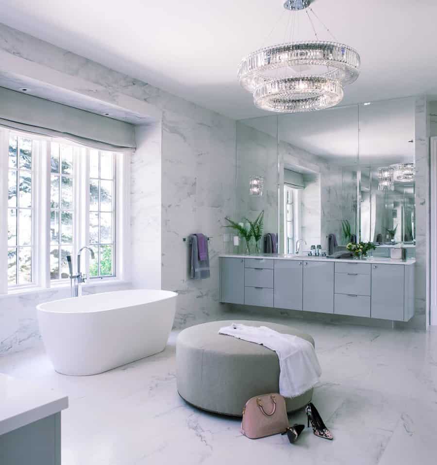 Marble bathroom with freestanding tub and crystal chandelier