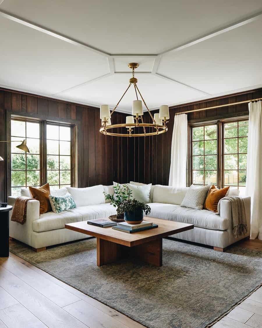 Elegant living room with dark wood paneling and white sofa